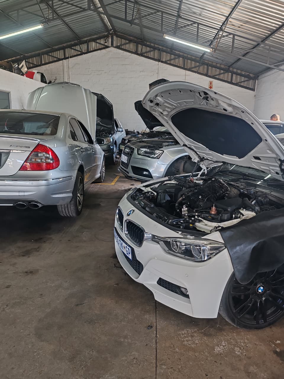Mercedes-AMG, Audi and BMW in the workshop with engine bays open